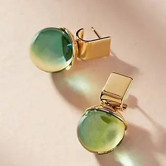 Vintage earrings with green crystal in golden